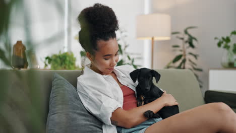 woman hugging a puppy on a sofa