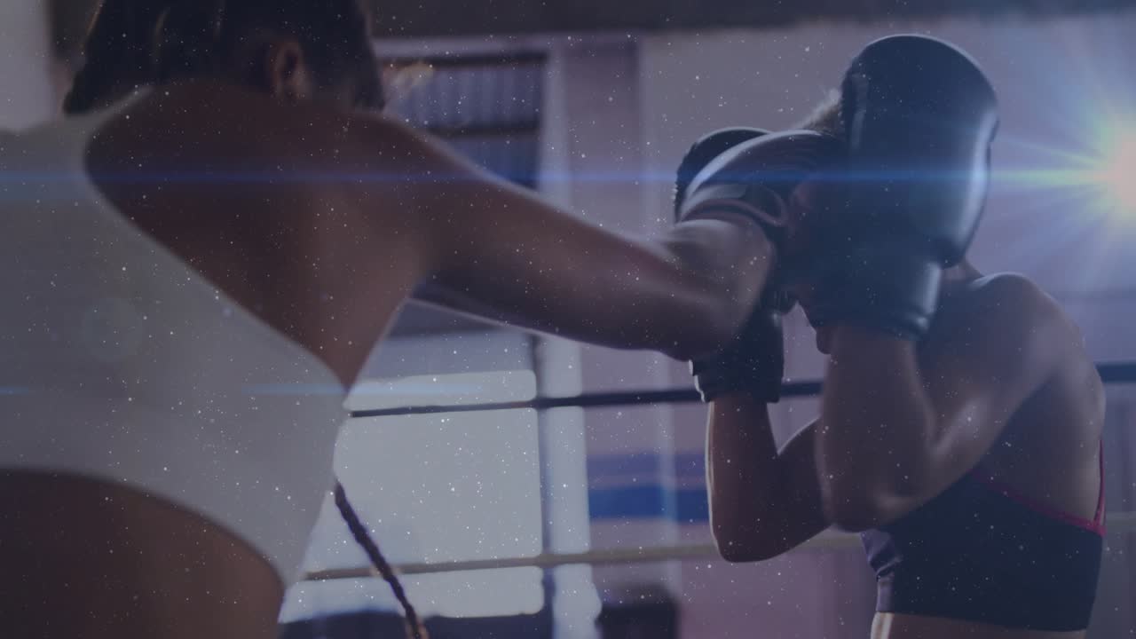 Left boxer jabbing during training, right boxer blocking, lines tracing gloves, boxing ring flare