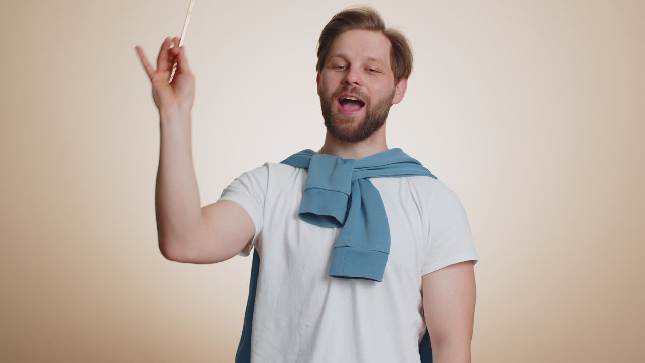 Magician wizard man gesturing with magic wand making wish come true casting magician spell