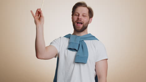 magician wizard man gesturing with magic wand making wish come true casting magician spell