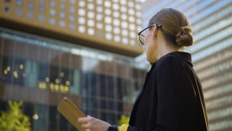 close-up cheerful businesswoman talking smartphone while looking on