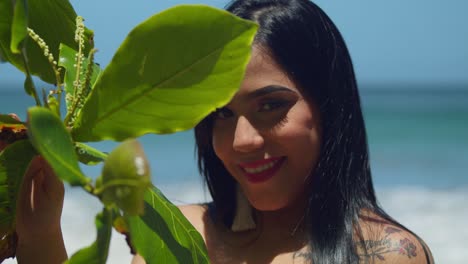 pretty facial close up of a young woman on the beach in the caribbean