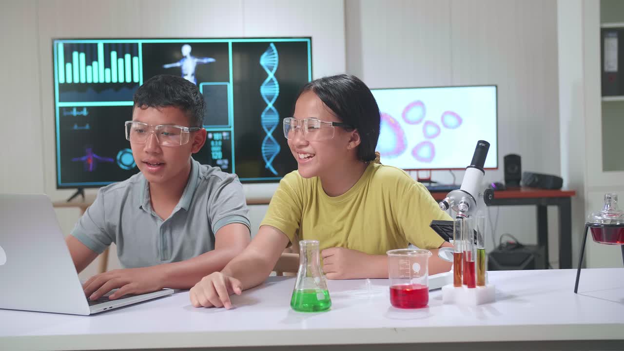 Young Asian Boy And Girl Learning Science Experiment In Laboratory At Classroom. Study With Computer And Scientific Equipment