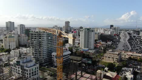 A-beautiful-dominican-flag-on-the-top-of-a-crane-on-the-contruccion-site-of-hard-rock-hotel-on-Santo-Domingo,-Dominican-Republic