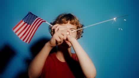 woman holding american flag and sparkler