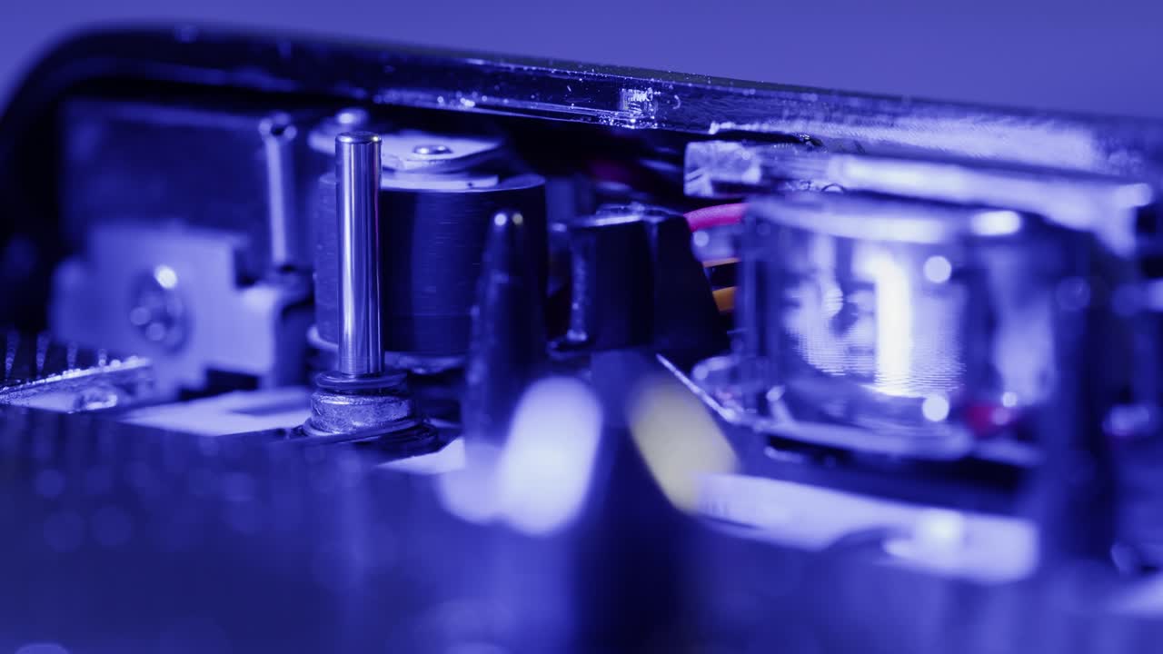 Close-up of a vintage audio cassette tape showing wear marks and magnetic tape reels in retro style.