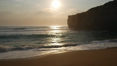 the late afternoon sun over the ocean behind a cliff near port campbell, victoria, australia, december 2019