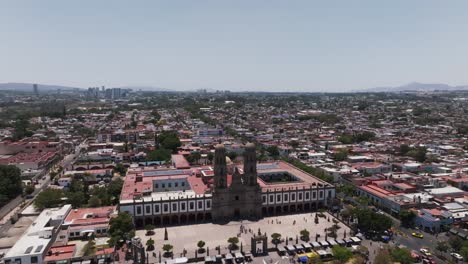 Guadalajara,-Mexico-cityscape-and-Basilica-of-Our-Lady-of-Zapopan,-drone-shot