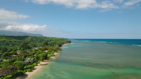 wide aerial dolly moving forward alongside anini beach, kauai, hawaii