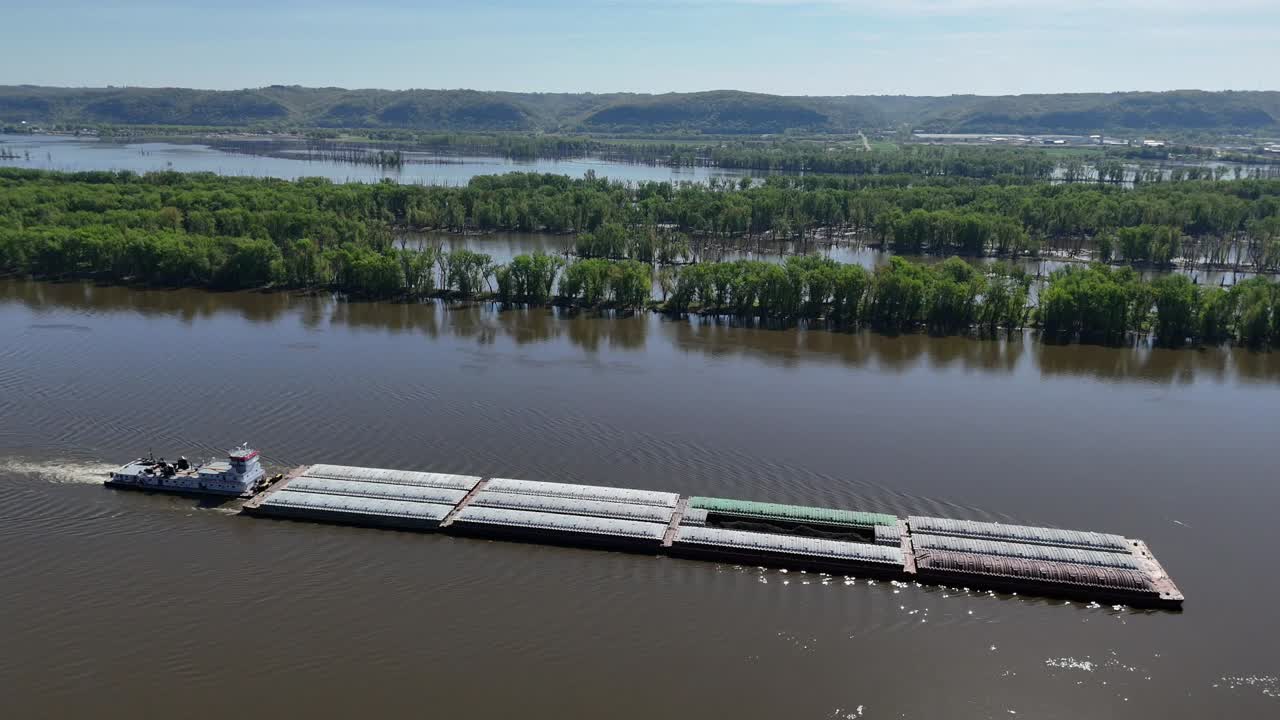 Located along the Mississippi River between Minnesota and Wisconsin's Driftless area, a towboat move a set of barges south.