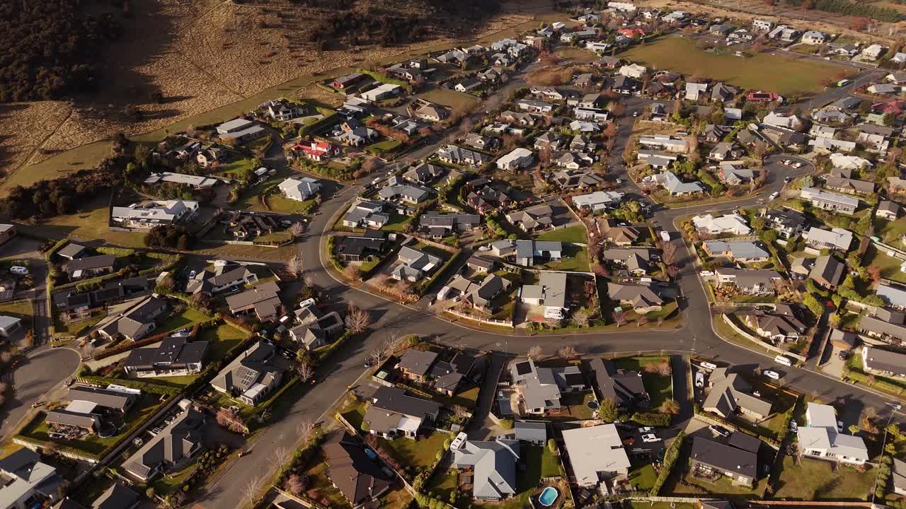 Wide 4K 60fps top-down drone view showing a broad overview of a residential neighbourhood in Wanaka, NZ. Excellent for establishing a suburban setting or for real estate projects