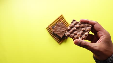 hand holding a chocolate hazelnut brownie