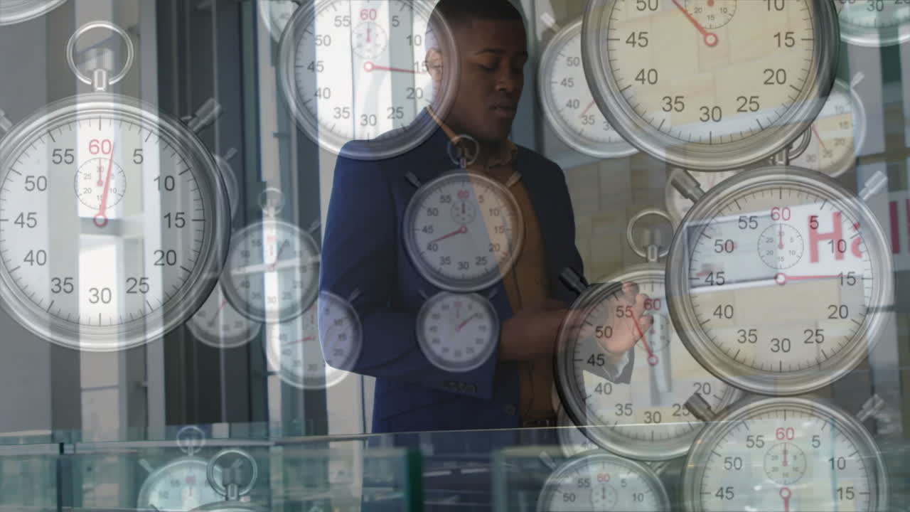 Animation of clocks ticking over african american businessman in office