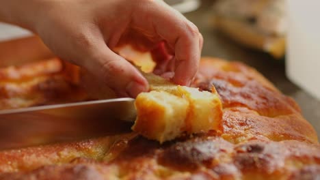 Slicing-fresh-bread-made-from-ingredients-harvested-from-organic,-sustainable-farms-in-the-Amazon-rainforest-into-cubes---close-up