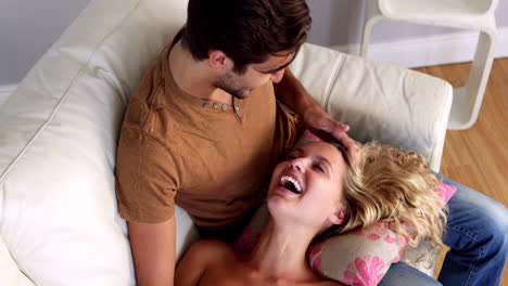 girl lying on the lap of her boyfriend on the couch
