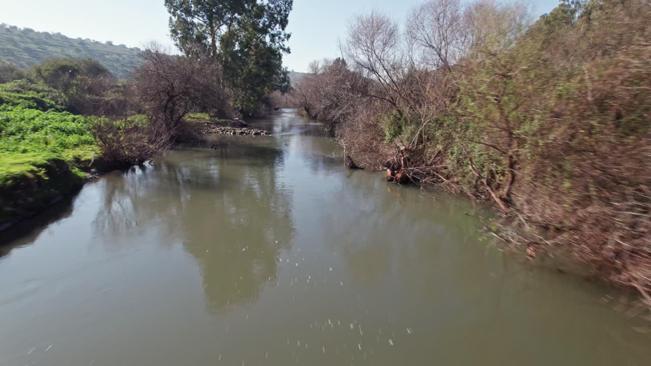 A drone flight over the water of the Jordan River.