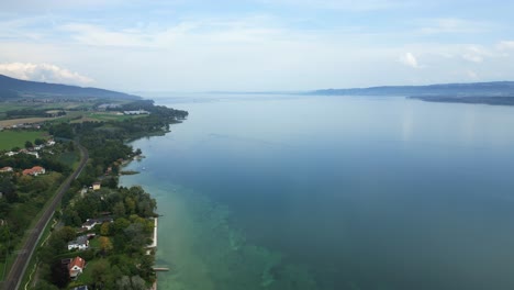 push in drone shot of lake neuchatel near grandson in canton of vaud in switzerland