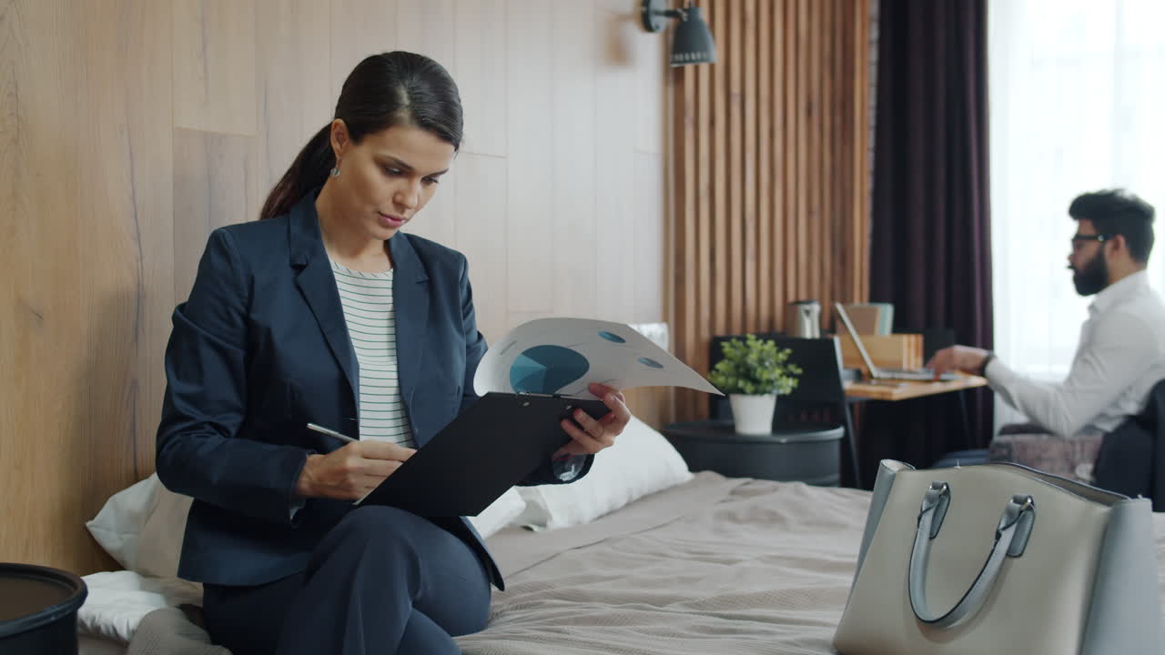 Businesswoman Working in Hotel Room