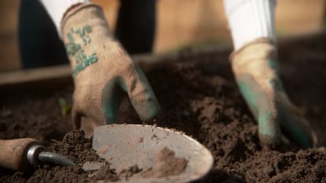 gardener turns dirt with hands 2000 fps phantom