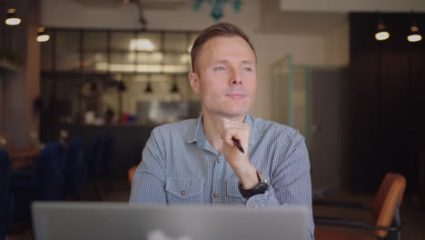 Thoughtful-serious-young-man-student-writer-sit-at-home-office-desk-with-laptop-thinking-of-inspiration-search-problem-solution-ideas-lost-in-thoughts-concept-dreaming-looking-away