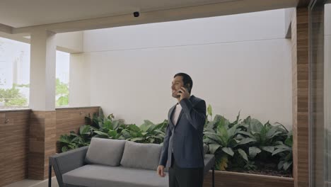 confident executive man standing outdoors, talking on the phone and celebrating a successful business deal.