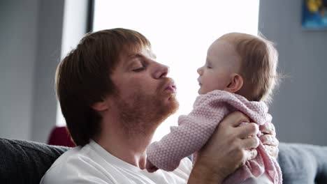 padre feliz hablando con la dulce hija bebé
