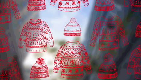 animación de sudaderas y sombreros navideños sobre el fondo del paisaje urbano