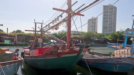 colorful fishing boats moored in a busy harbor