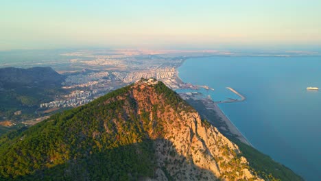 Aerial-4K-drone-video-of-a-Tunektepe-Teleferik
Cable-station-positioned-on-top-of-the-hill-with-the-mountains-in-the-background