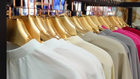 colorful shirts on hangers in a store