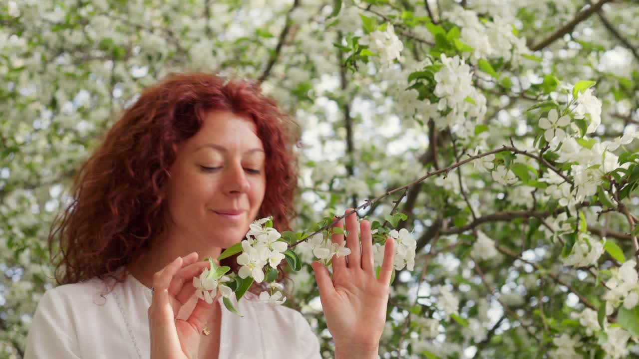 Woman enjoying apple blossoms in spring