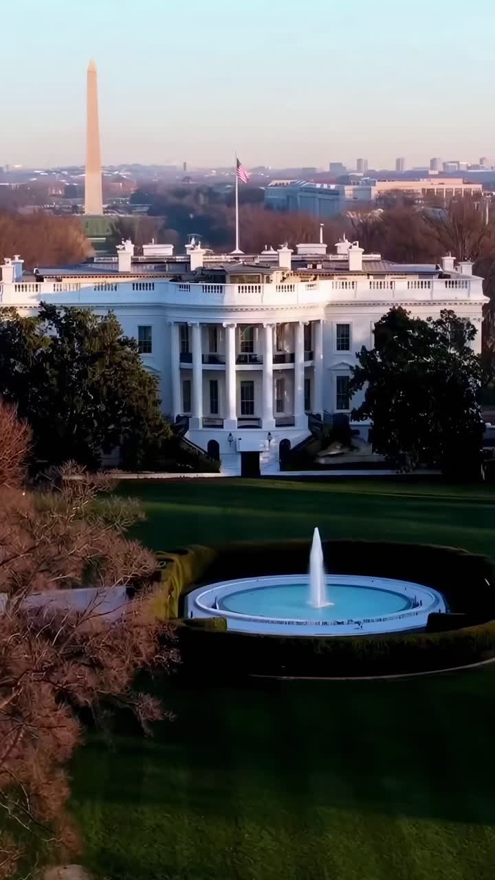 Vídeo aéreo de um grande edifício branco com uma fonte, capturando uma vista majestosa.