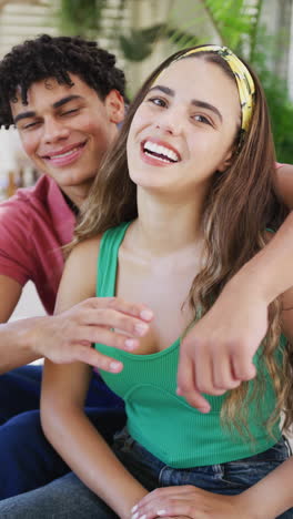 vertical video of portrait of happy biracial couple spending time at home and embracing