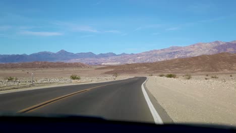 car driving on the road at death valley national park in california, usa