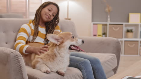 african girl and happy corgi dog