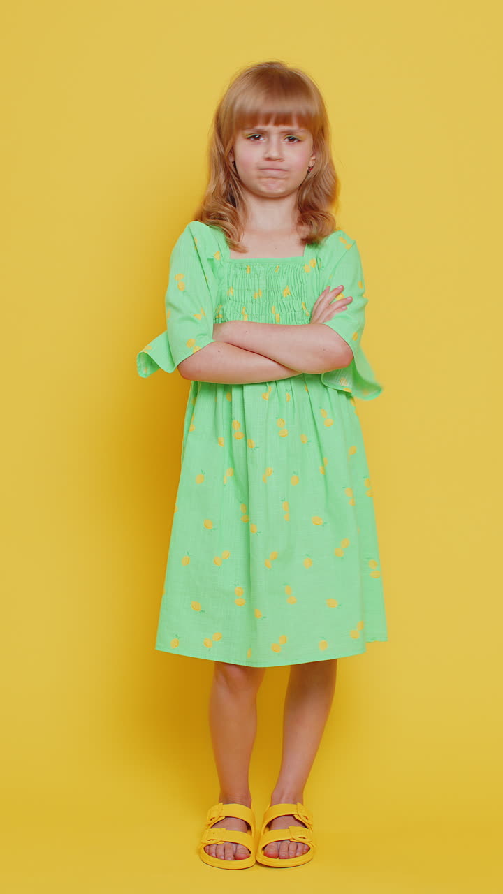 Upset preteen child girl showing thumbs down dislike bad work disapproval dissatisfied feedback