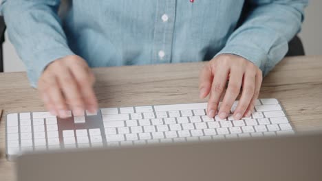 close up hand of a business woman typing keyboard desktop computer on desk office