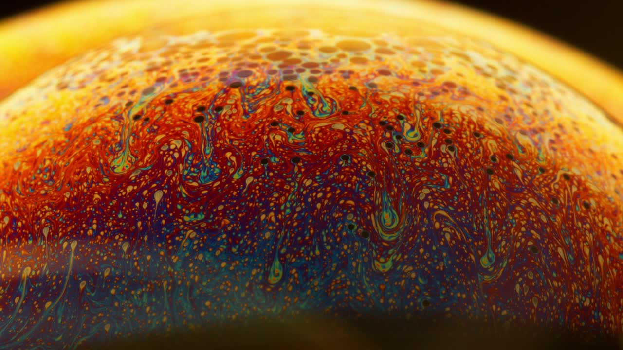 Abstract Macro Shot Fluid in Colorful Spectrum Swirling on the Surface