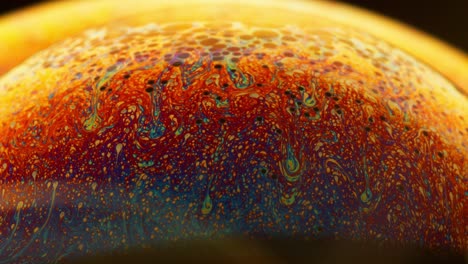abstract macro shot fluid in colorful spectrum swirling on the surface