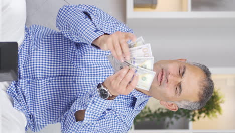 Vertical-video-of-The-rich-man-with-money-is-happy.