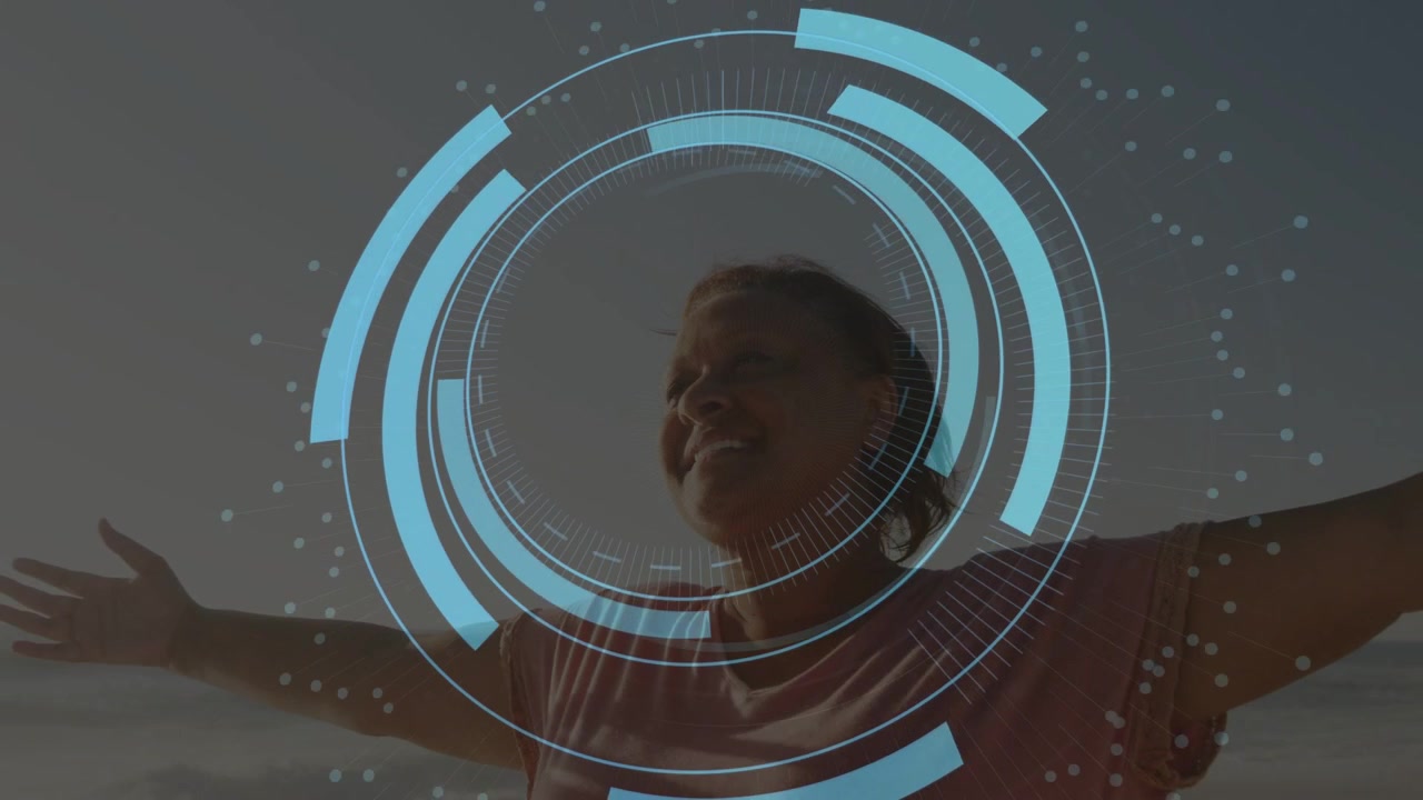 Senior woman standing shore raising arms as dotted arc sparking HUD rings over torso for healthtech