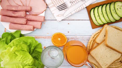 food for breakfast on the table moving - bread, salad, cucumber, salami, juice - stop motion