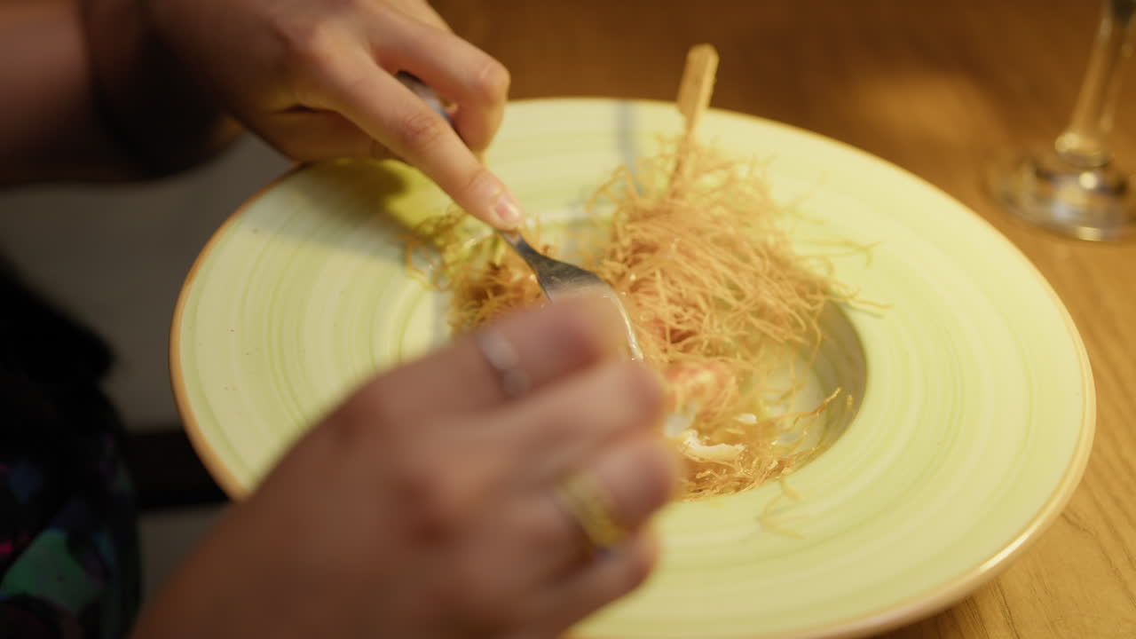 Fork Removing Shrimps From The Skewer Inside The Gourmet Dish