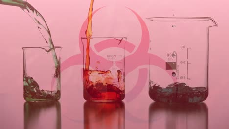 Health-hazard-sign-with-liquid-flowing-into-a-beakers-with-Covid-19-spreading-on-red-background