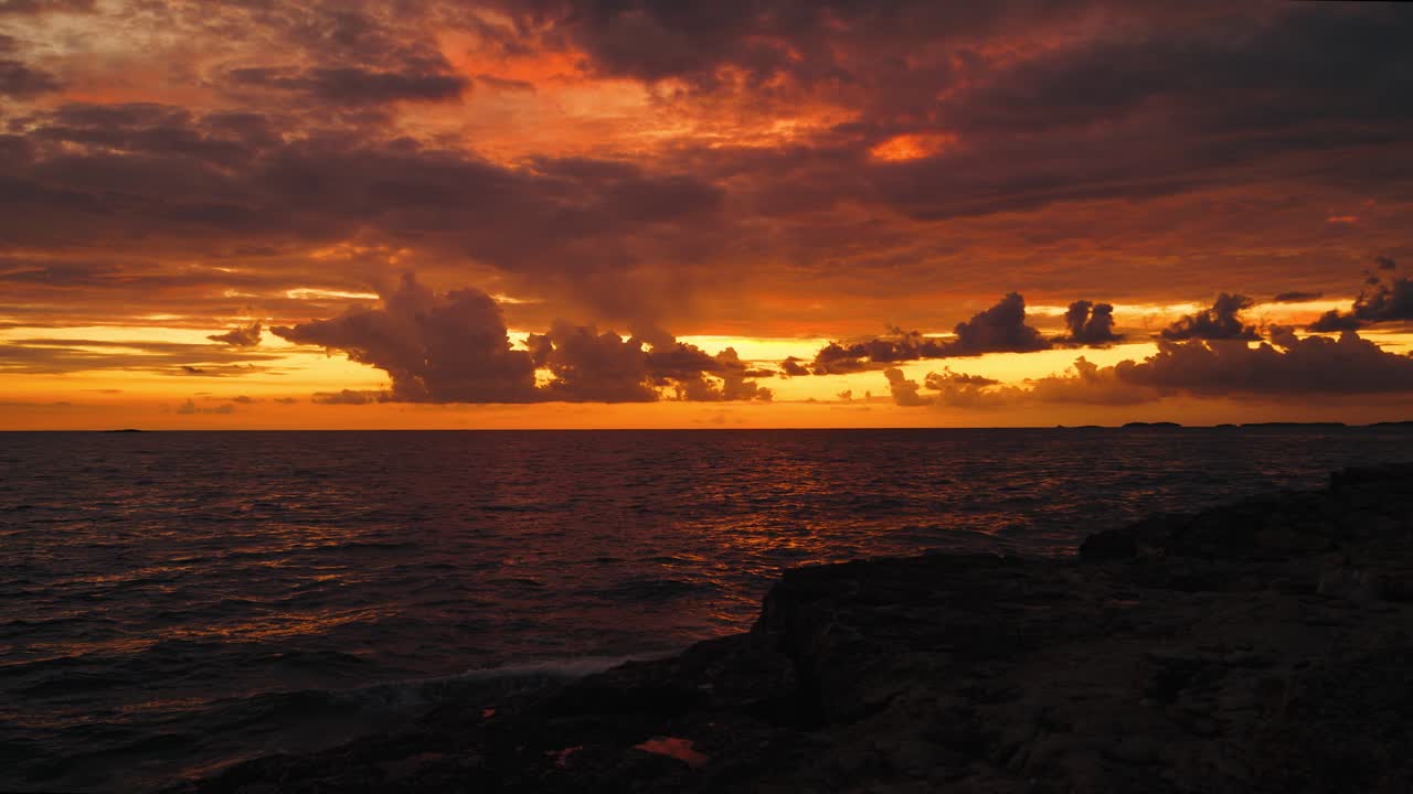 Scenic evening sunset at the Istrian seaside coast with colorful clouds and calm Adriatic sea waves