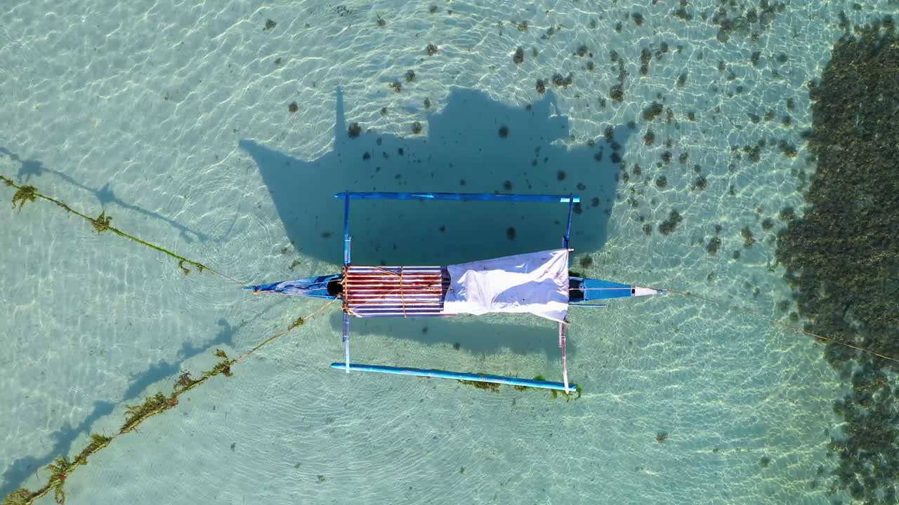 stunning crystal clear sea water with a traditional Philippine boat (Bangka)