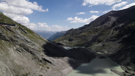 alpine lake water from the fastest melting pasterze glacier at the foot of the grossglockner mountain in the austrian alps, drone shot