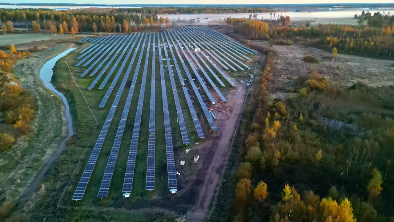 Aerial view of solar farm at sunrise in autumn, showcasing sustainability