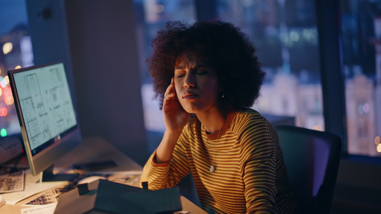 Property manager unmotivated work overtime sitting evening workplace closeup