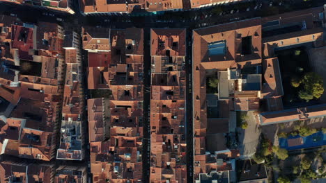 Aerial-birds-eye-overhead-top-down-view-of-buildings-and-narrow-streets-in-old-city-centre.-Red-tiled-roofs-from-above.